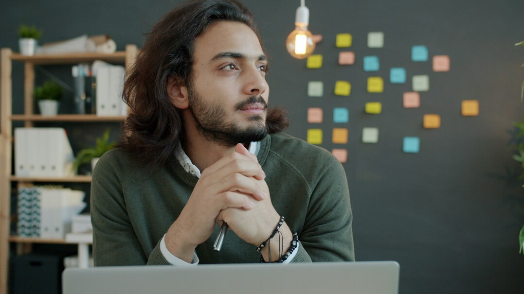 person thinking deeply at desk