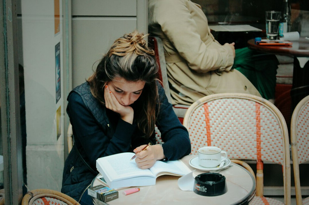 woman writing notes thoughtfully