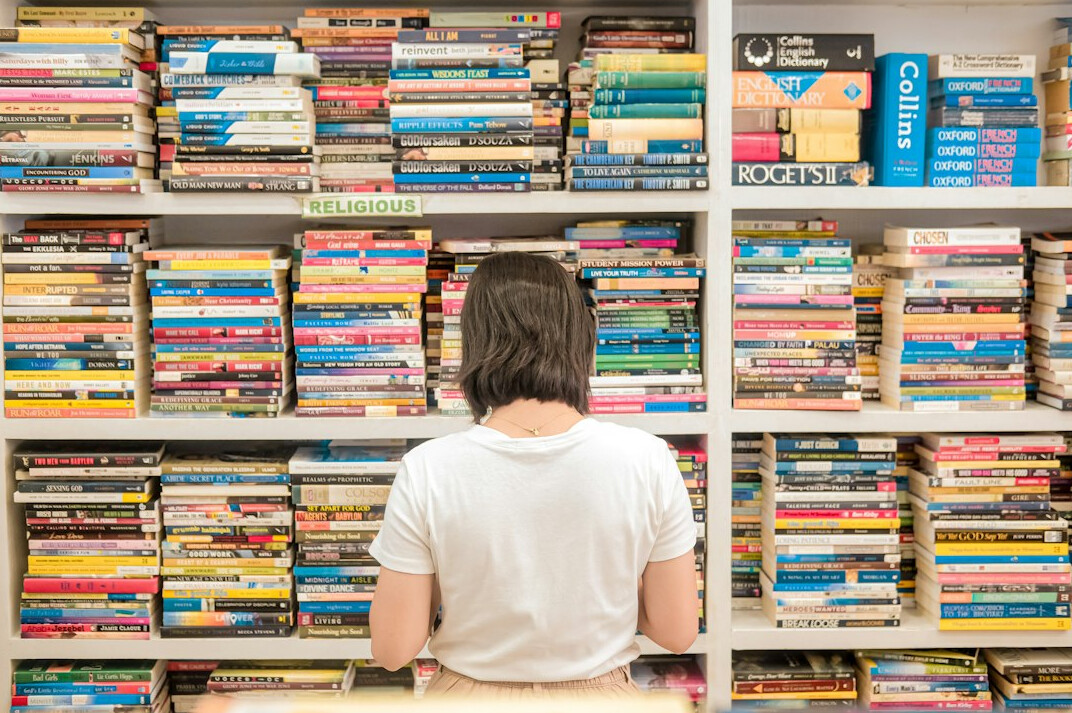 person reading book in library