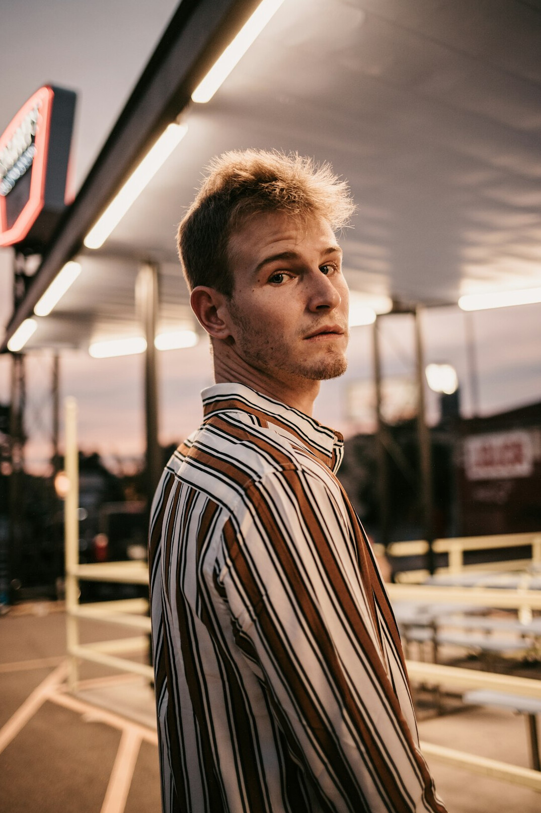 Portrait of a man with short hair in a casual shirt