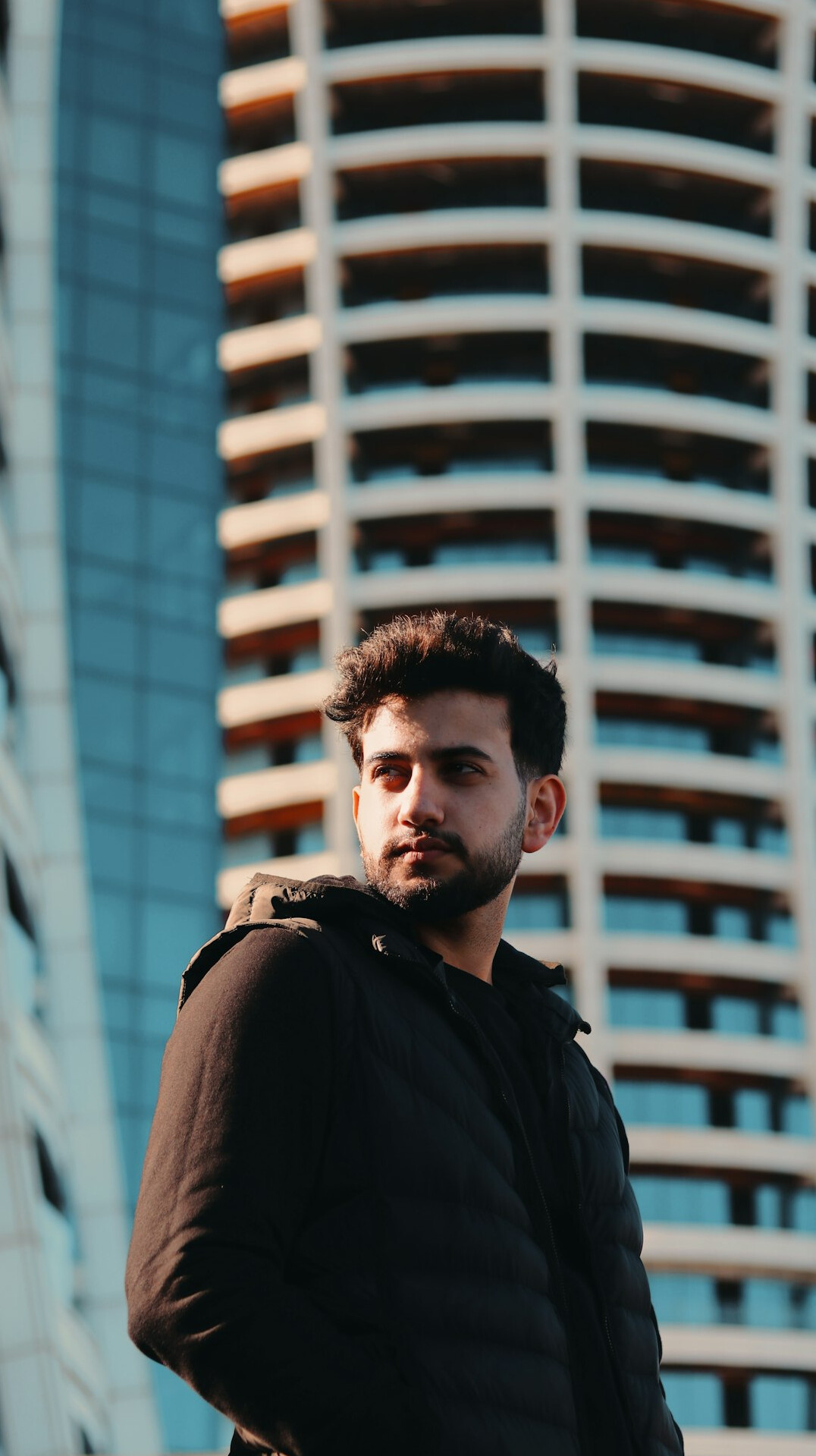 Portrait of a man with a beard in a dark jacket